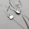 Macro shot of rabbit-shaped black mother of pearl shell beads with iridescent luster - Vertical Hole Rabbit Head / Black