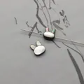 Detailed view of rabbit-shaped black shell beads with natural iridescence for DIY jewelry - Horizontal Hole Rabbit Head / Black