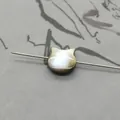 Macro shot of owl-shaped natural shell bead with iridescent luster and center drill hole - Horizontal Hole Cat Head / Black