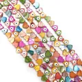Macro shot of colorful heart-shaped shell beads with evil eye detail for DIY jewelry - Heart Style A