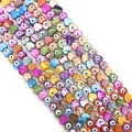 Macro detail of heart-shaped shell beads with evil eye pattern for DIY jewelry - Heart