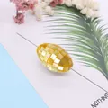 Macro shot of an oval golden mosaic shell bead for DIY jewelry and necklace crafting - 18x25mm / Yellow Shell
