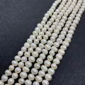 Four strands of white natural freshwater pearls for DIY jewelry making on dark background - 2-3mm / White