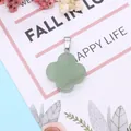 Macro view of green natural stone clover pendant with polished finish and silver bail - Green Aventurine