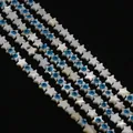 Macro shot of star-shaped shell beads with blue evil eye charms for DIY jewelry making - 8mm / Pentagram