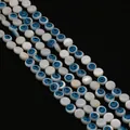 Detailed macro view of natural shell beads with evil eye pattern for DIY jewelry - 6mm / Disc