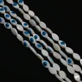 Macro detail of marquise mother of pearl evil eye beads for DIY necklace jewelry making - 5x10mm / Marquise