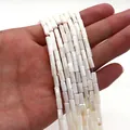 Detailed view of hand holding natural white shell cylindrical beads for DIY jewelry - Cylinder Style (1006-B220827015) / 4x8mm (11g) / No.4 (Creamy White)