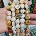 Handheld view of multi-color flat round natural stone beads for DIY jewelry making - 16x16x6mm / Colorful Agate (No. 27)
