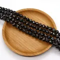 Dettaglio macro di perle nere tonde con intarsio in madreperla a mosaico per gioielli DIY - 10mm / Nero