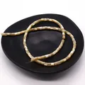 Natural cylindrical shell beads for DIY jewelry making displayed on a black matte tray - 3.5x3.5mm / Natural
