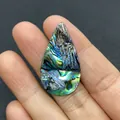 Macro shot of droplet-shaped abalone shell bead with vibrant iridescent blue-green colors - Teardrop / 19x35mm