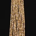 Macro view of golden natural shell beads with pearlescent finish for DIY jewelry making - 3x4mm / Natural