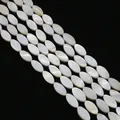 Close-up of natural white mother of pearl oval beads for DIY jewelry making - Marquise