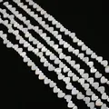 Close-up of heart-shaped natural freshwater shell beads with white iridescent luster - Horizontal Hole Heart Shape