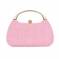 Macro detail of pink woven texture and light gold metal handle on evening clutch bag - Pink
