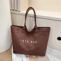 Minimalist dark brown suede tote bag with white text print for daily commute - Coffee