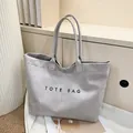 Minimalist grey suede tote bag with black TOTE BAG print for daily commuting - Gray