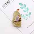Detail of natural raw amethyst stone pendant with gold plating and metallic loop - Citrine and Amethyst