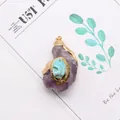 Macro shot of irregular amethyst pendant with turquoise inlay and gold plated edges - Amethyst and Blue Turquoise