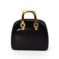Close-up of black stone handbag pendant with detailed golden textured metal handle - Black Agate (1034-T220802002)