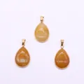 Three teardrop-shaped yellow stone pendants with gold plated metal edges and bails - Coral Jade