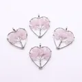 Detail of heart-shaped life tree pendants with pink natural stones and silver wire wrapping - Rose Quartz