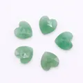 Macro shot of 5 faceted heart-shaped green natural stone pendants with top-drilled holes - Green Aventurine