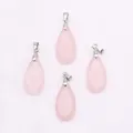 Detailed view of faceted pear-shaped rose quartz crystal pendants with silver metal clasps - Rose Quartz