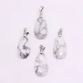 Detailed view of four teardrop-shaped white howlite stone pendants with marble texture - Howlite