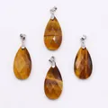 Macro shot of faceted teardrop Tiger Eye pendants with polished silver metal bails - 13x25mm / Tiger's Eye