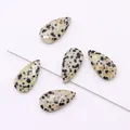 Close-up of teardrop-shaped Dalmatian Jasper bead with vertical hole for DIY jewelry making - Dalmatian Jasper