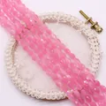Faceted oval pink cat eye stone beads on embroidery hoop for DIY jewelry making - Soft Pink