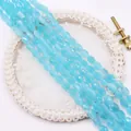 Detail of faceted oval light blue cat eye stone beads on elegant white lace background - Light Blue