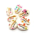 Macro shot of polished cowrie shells with colorful floral patterns and love hope scripts - Mixed Sentiment Collection Style