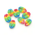 Macro view of nine rainbow-painted natural cowrie shells for DIY jewelry making - Horizontal Color Stripe