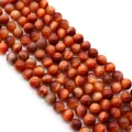 Detailed close-up of polished Red Tiger's Eye beads with natural cat-eye Chatoyancy effect - Red Brown (Style 10)