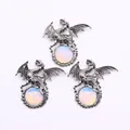 Three vintage silver dragon pendants clutching opalite gemstones on white background - Opal