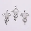 Macro detail of silver angel wing key pendants with white teardrop crystal stones - White Crystal