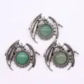 Macro detail of vintage silver dragon pendants with polished green malachite stones - Green Aventurine