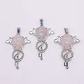 Detail view of pink crystal angel wing pendants with silver metal key-shaped base - Rose Quartz