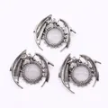 Detailed macro view of three vintage silver dragon pendants with white moonstone inlays - White Crystal