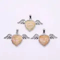 Macro shot of three angel wing heart pendants with natural stone inlay and silver finish - 30x53mm / Coral Jade