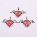 Detailed macro view of heart-shaped angel wing pendants with natural pink stone texture - 30x53mm / Watermelon Quartz