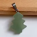 Detail shot of a semi-transparent light green natural stone Christmas tree pendant with silver clasp - Green Aventurine