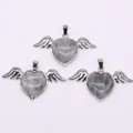 Macro shot of three silver angel wing pendants with heart-shaped natural gemstones - 30x53mm / Flash Stone (Labradorite)