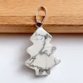 Macro shot of white turquoise Christmas tree pendant with silver bail and marble texture - Howlite
