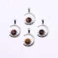 Silver crescent moon pendant set with brown tiger eye stone and sunburst detail - Tiger's Eye
