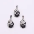 Silver swan pendant with black obsidian stone and hollow feather design detail - Black Spectrolite