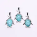 Drie pinguïnvormige zilveren hangers met turkooisstenen en zwarte adertextuur - Blauw Turkoois